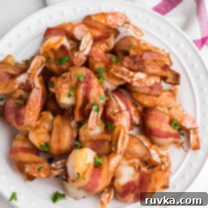 Crispy Air Fryer Bacon Wrapped Shrimp 8 Overhead shot of crispy air fryer bacon wrapped shrimp, garnished with fresh parsley.