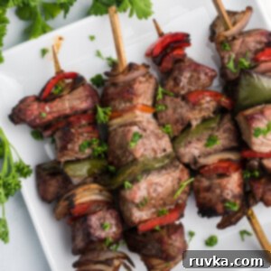 Easy Air Fryer Beef Recipes 7 Air fryer steak kabobs with colorful bell peppers and onions, ready to serve.