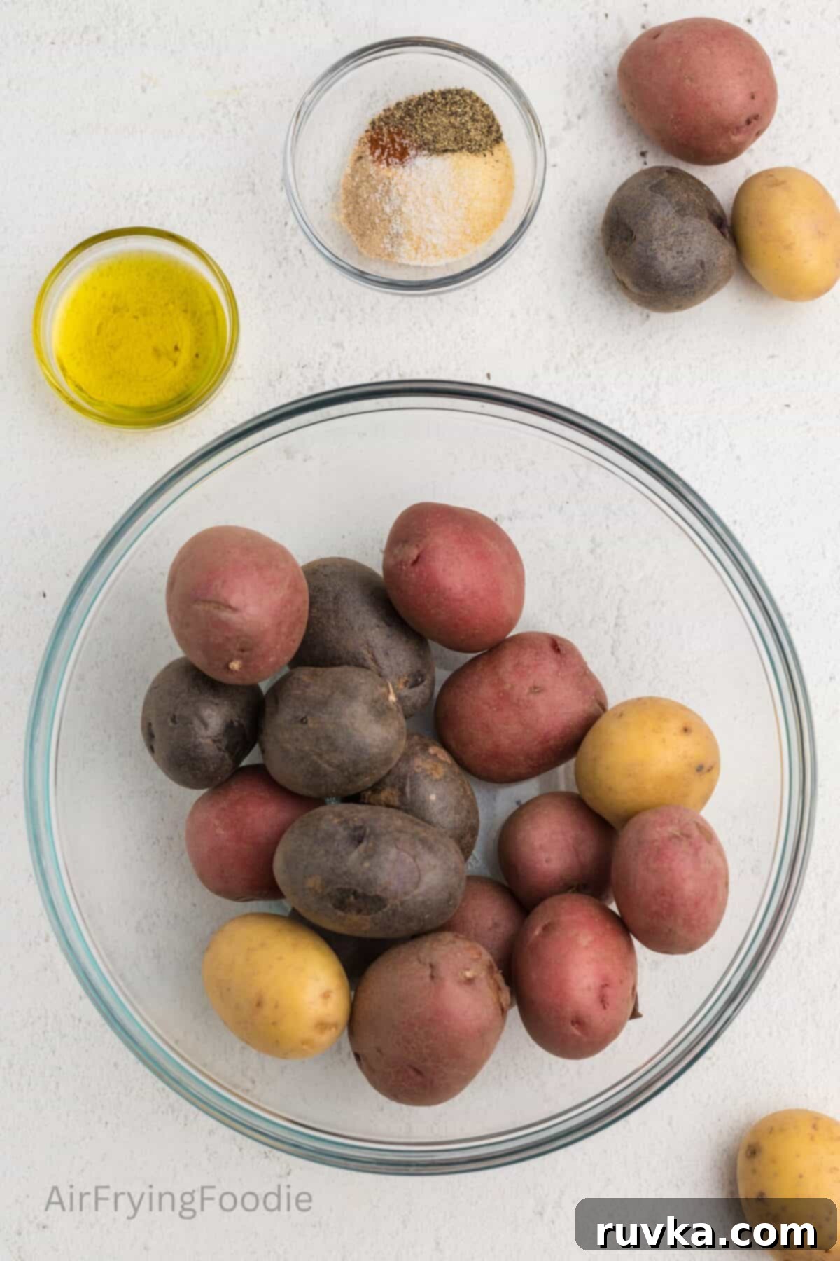 Crispy Air Fryer Roasted Potatoes 3 Ingredients on a white tabletop used to make roasted potatoes in the air fryer.