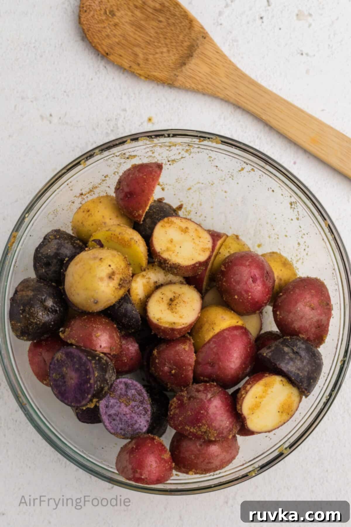 Crispy Air Fryer Roasted Potatoes 5 Cut potatoes in a mixing bowl, coated with olive oil and seasonings.