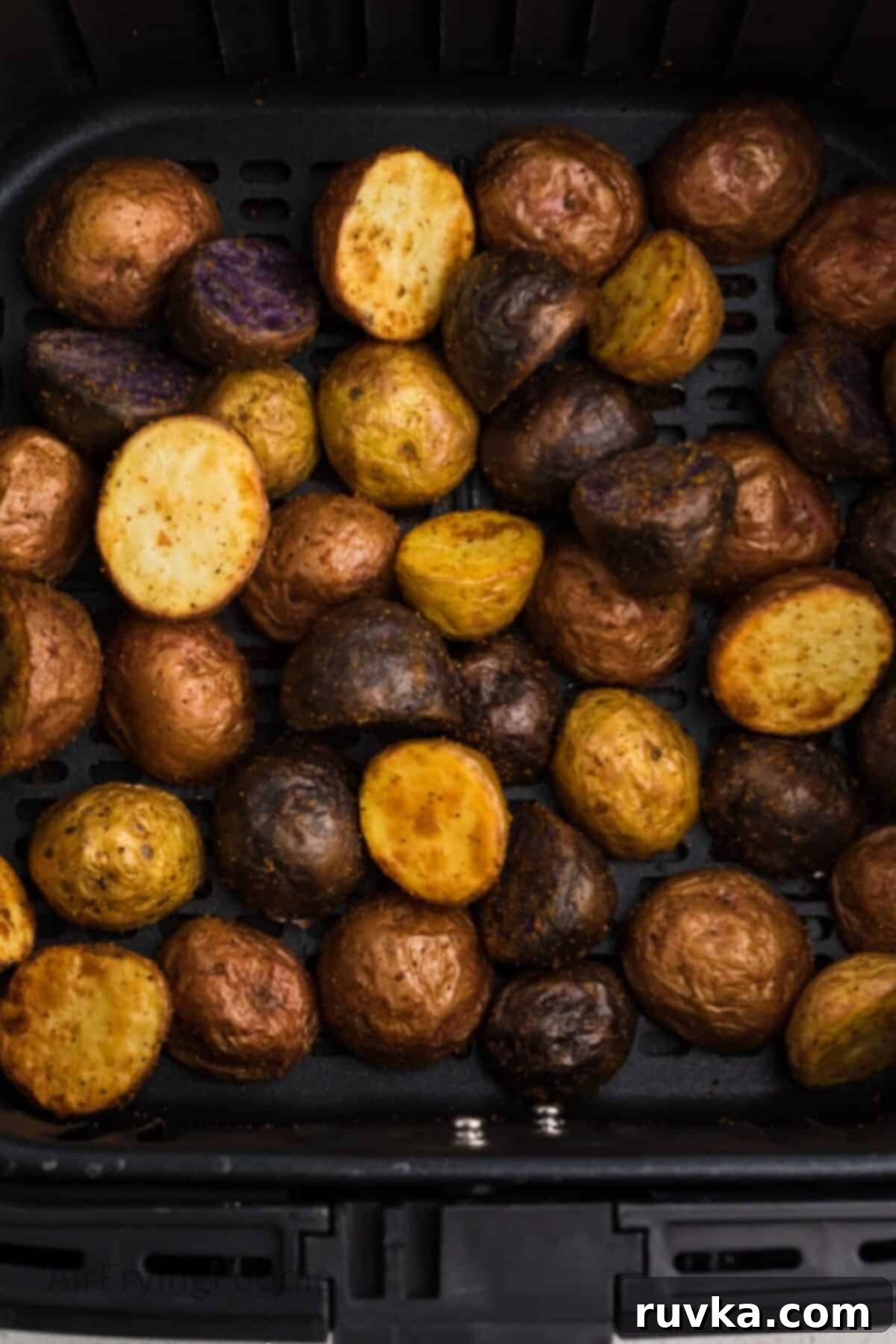 Crispy Air Fryer Roasted Potatoes 7 Crispy roasted potatoes in air fryer basket.