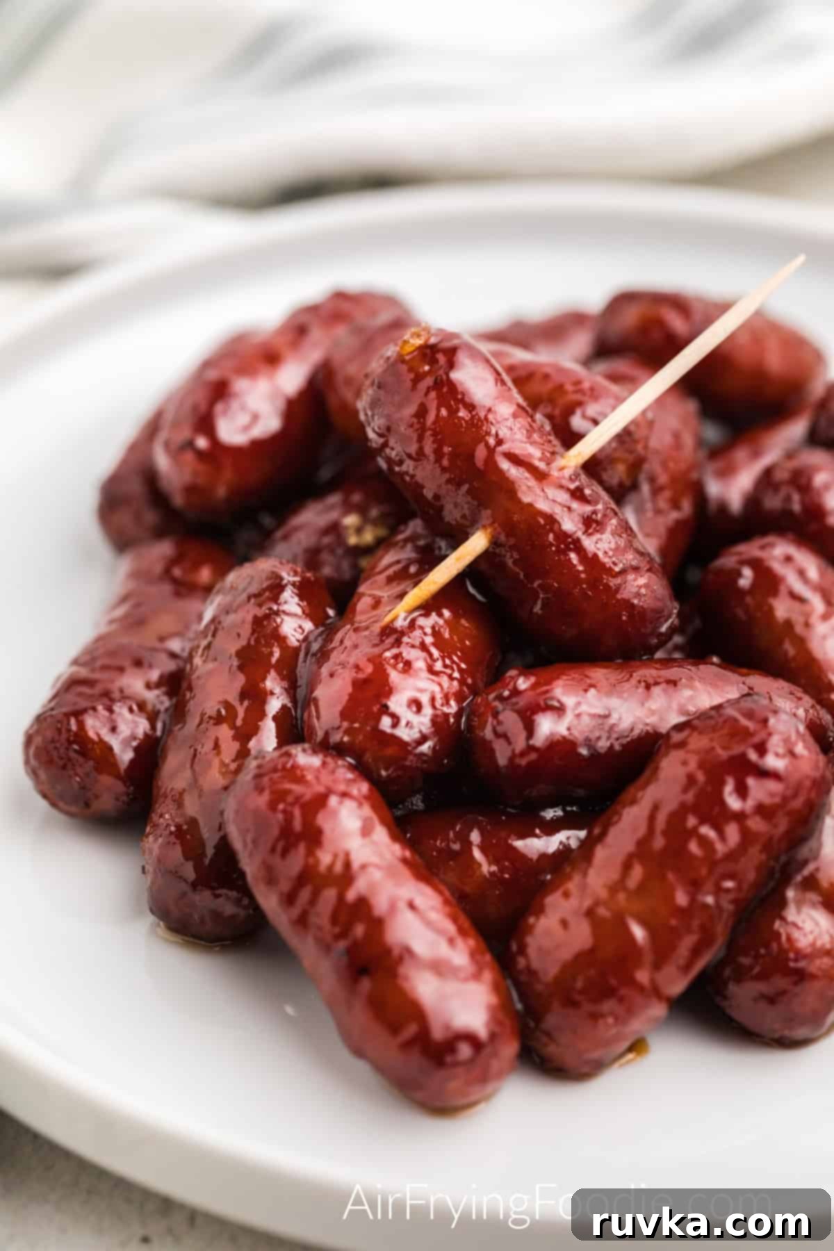 Easy Air Fryer BBQ Little Smokies 5 Air Fried BBQ Little Smokies in a white plate ready to serve.