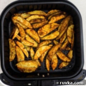 Crispy Air Fryer Potato Wedges 9 Golden cooked potato wedges seasoned in the air fryer basket.