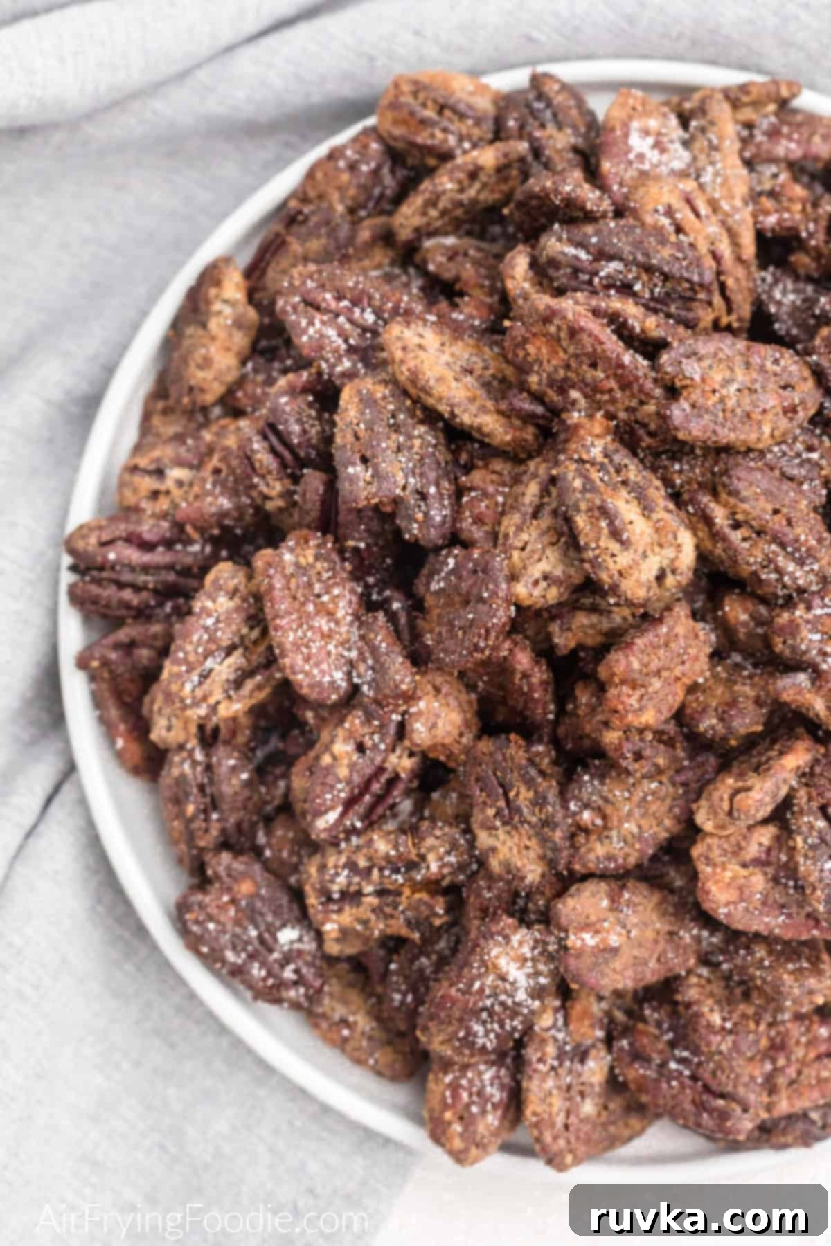 Golden Air Fryer Candied Pecans 2 Bowl of candied pecans made in the air fryer, glistening with a sweet coating.