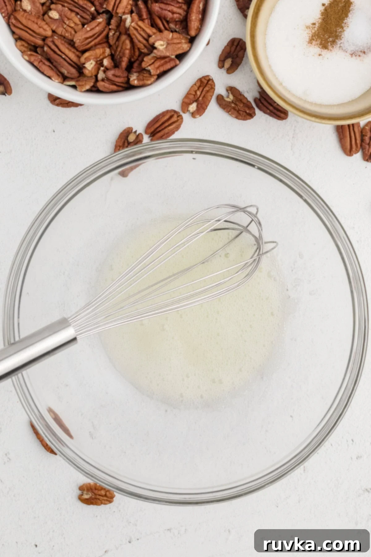 Golden Air Fryer Candied Pecans 4 Egg white and water whisked together until frothy in a small bowl, ready for pecans.