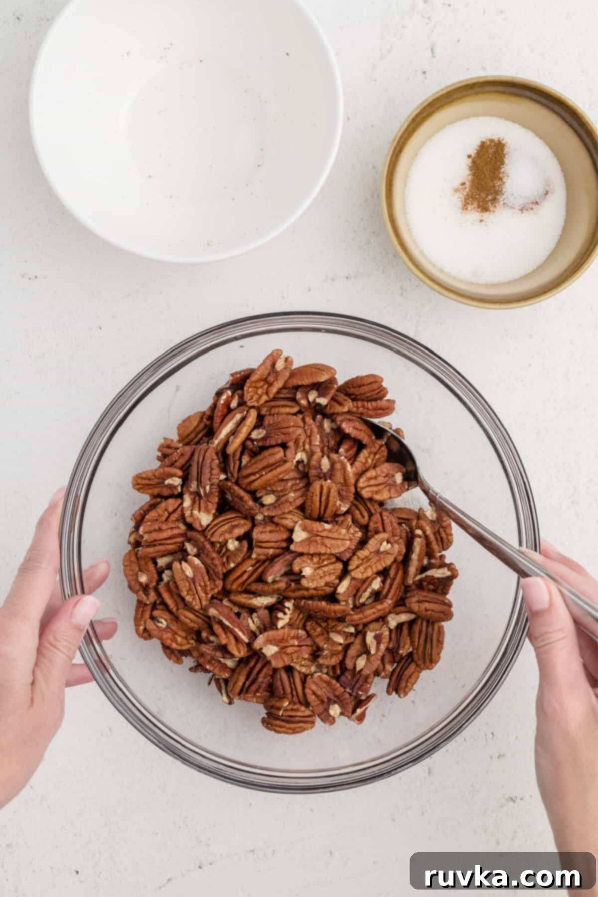 Golden Air Fryer Candied Pecans 5 Pecan halves mixed into the frothy egg white mixture, fully coated and ready for sugar.