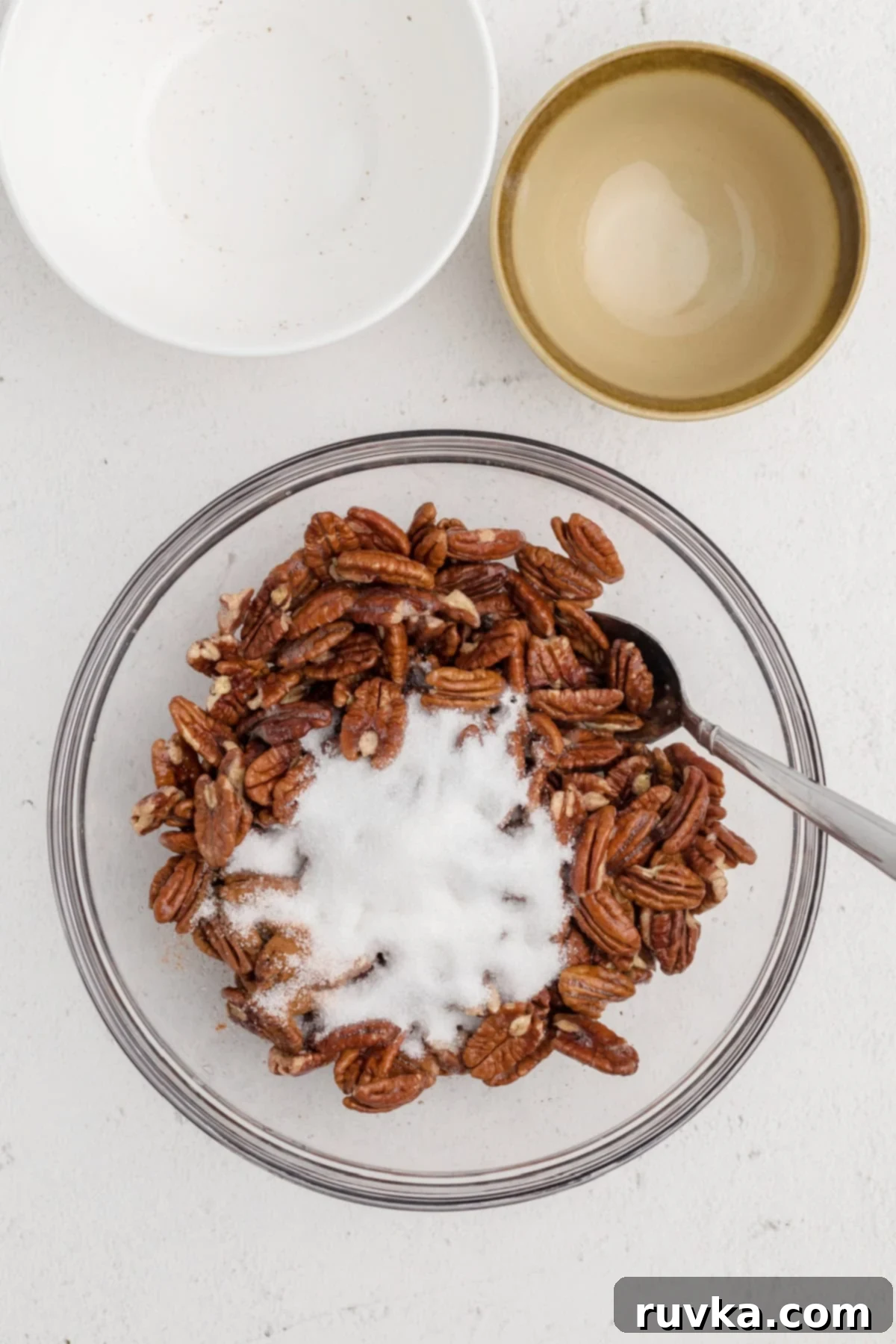 Golden Air Fryer Candied Pecans 6 Cinnamon and sugar mixture added to the pecans coated in egg whites, being tossed to combine.