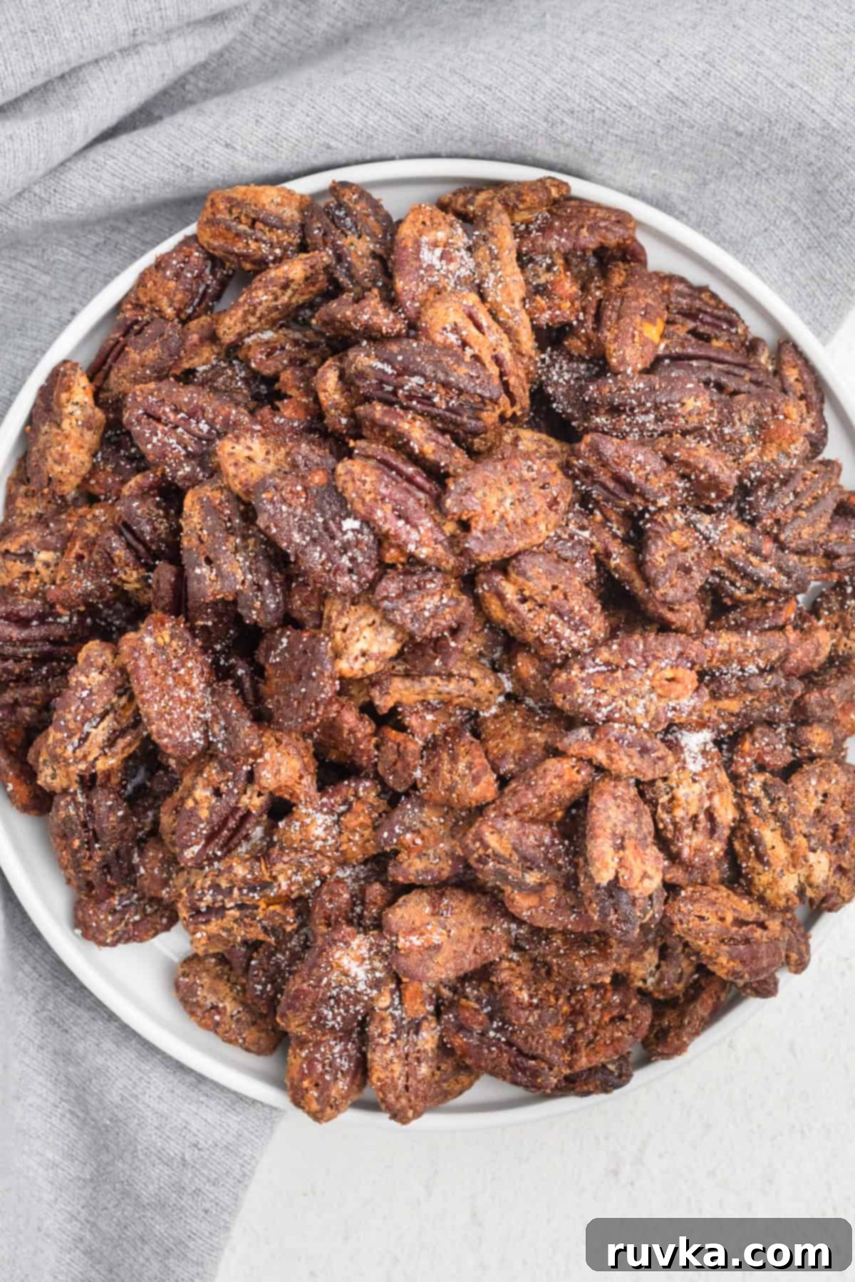 Golden Air Fryer Candied Pecans 9 Close-up of air fryer sugared pecans in a bowl, showing the crisp, sweet coating.