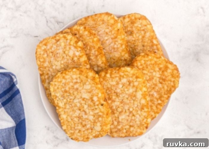 Golden Crispy Air Fryer Hash Browns 3 A stack of frozen hash brown patties, showing their uncooked, pale appearance before being transformed into crispy breakfast delights in the air fryer.