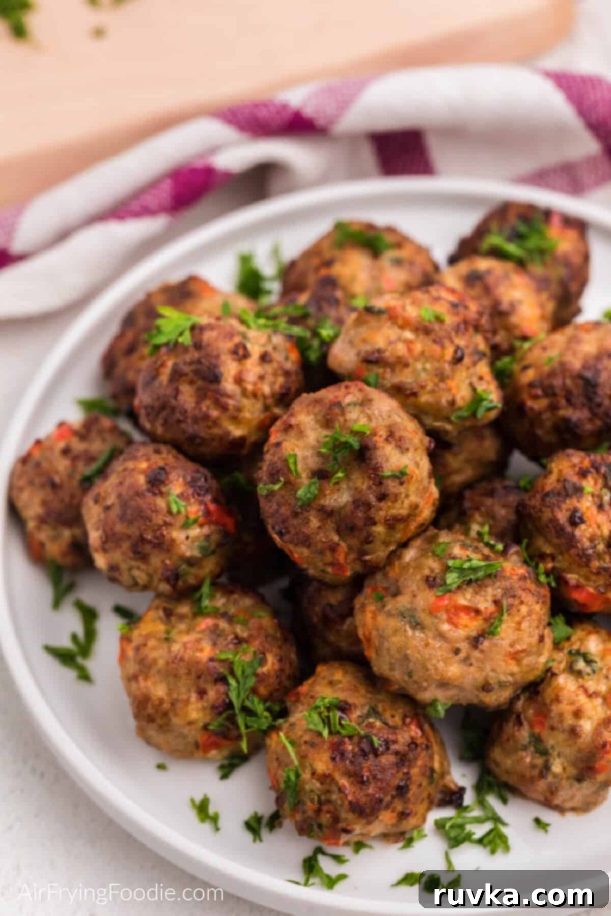 Crispy Air-Fried Turkey Meatballs 3 Close up of air fryer turkey meatballs on a white plate, ready to serve.