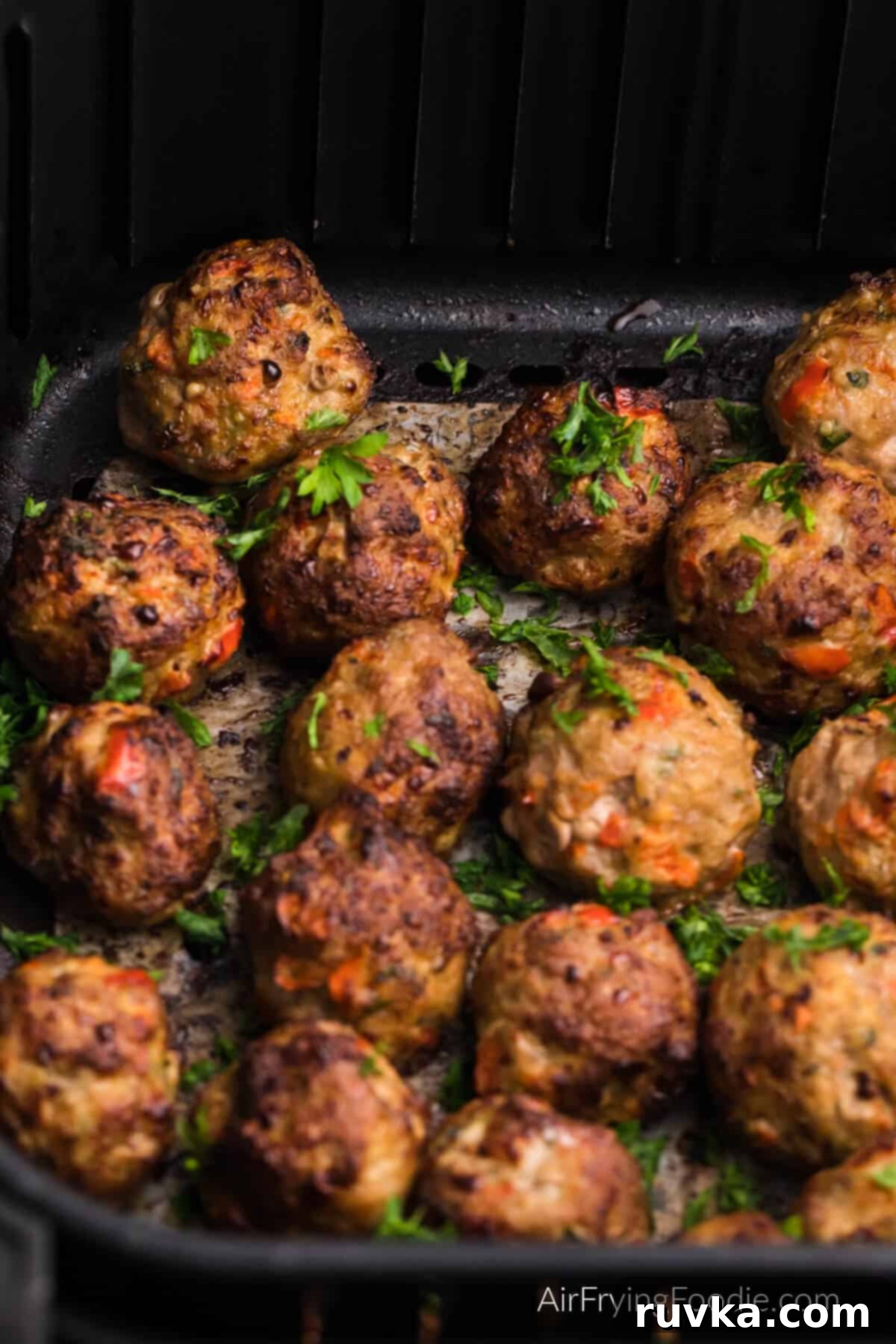 Crispy Air-Fried Turkey Meatballs 8 Turkey meatballs in air fryer basket, ready to remove and serve.