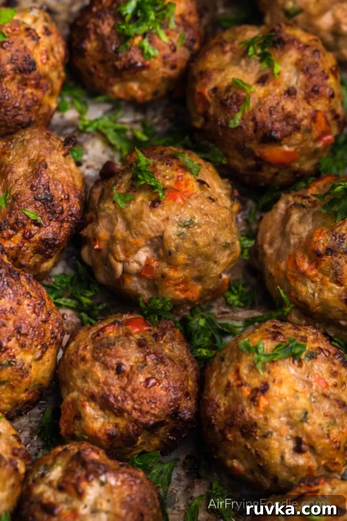Crispy Air-Fried Turkey Meatballs 9 Close up photo of turkey meatballs in air fryer basket.