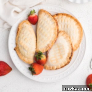 Easy Air Fryer Strawberry Cream Cheese Pie 7 Strawberry Cream Cheese Hand Pies made in the Air Fryer on a white plate