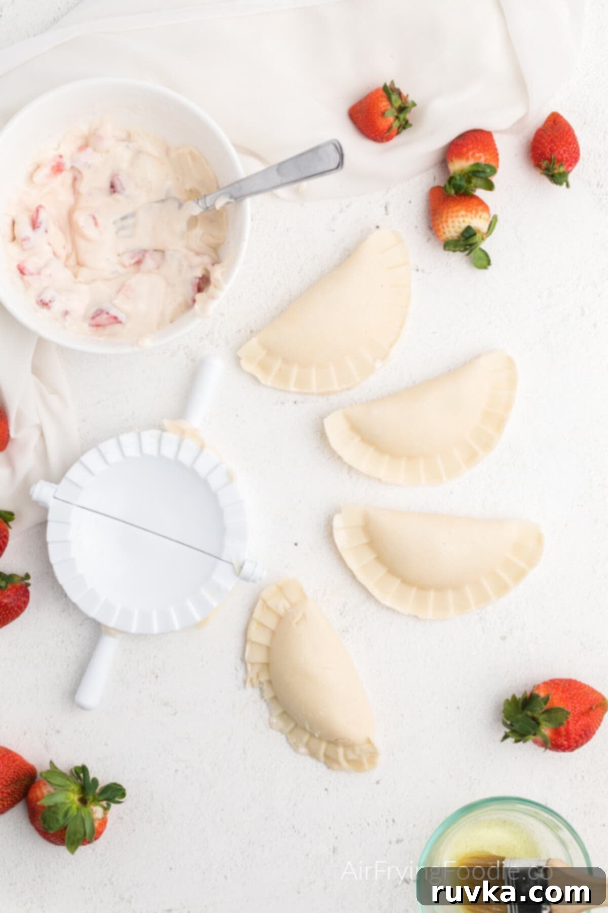 Easy Air Fryer Strawberry Cream Cheese Pie 4 Strawberry cream cheese hand pies crimped and ready to cook in the air fryer.