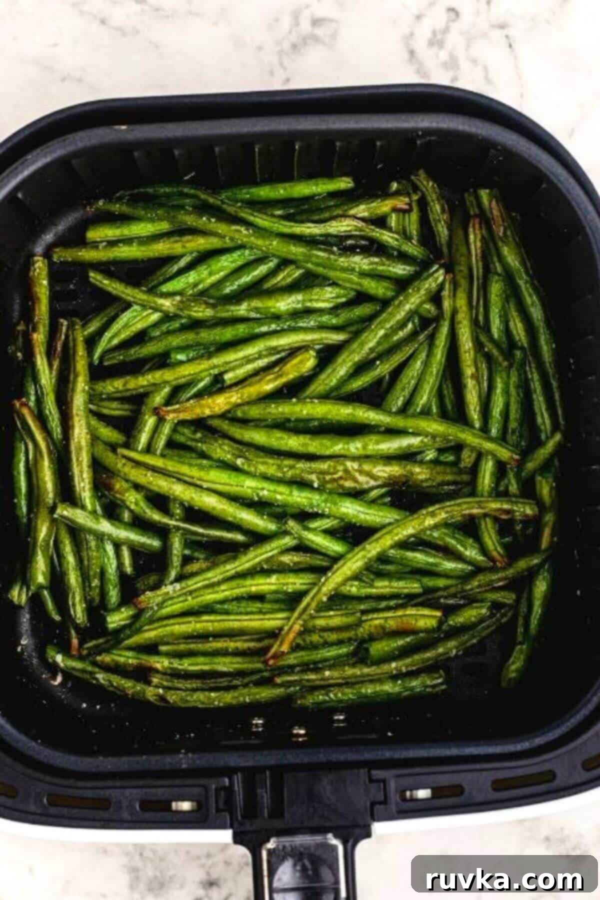 Crispy Air Fried Green Beans 6 Juicy and crispy cooked green beans in the air fryer basket.