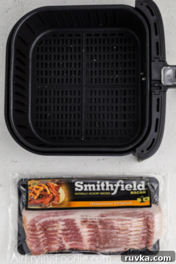 Crispy Air Fryer Bacon 3 Package of bacon and the basket of the Air fryer.
