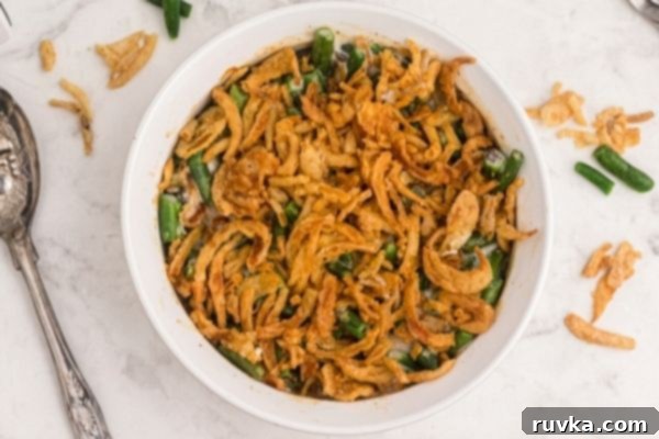 Crispy Air-Fried Green Bean Bake 2 Golden fried onions on top of green bean casserole in a white pyrex dish.