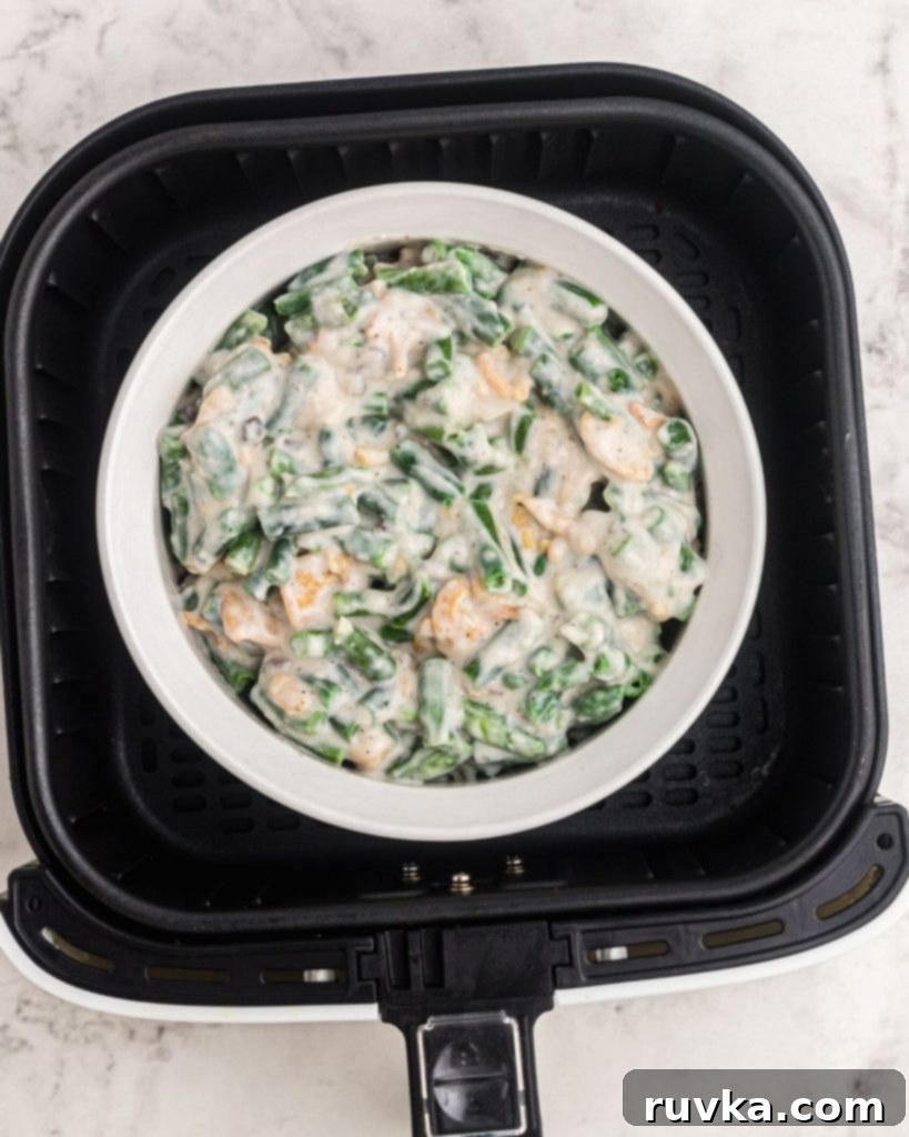 Crispy Air-Fried Green Bean Bake 5 Casserole before being cooked in a pyrex dish in the air fryer basket.