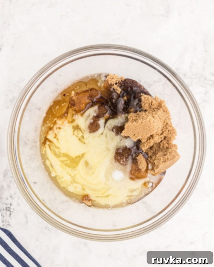 Perfect Air Fryer Pecan Pie 4 A bowl filled with the dry ingredients for pecan pie filling, waiting to be combined, showing the distinct textures of sugar and spices.