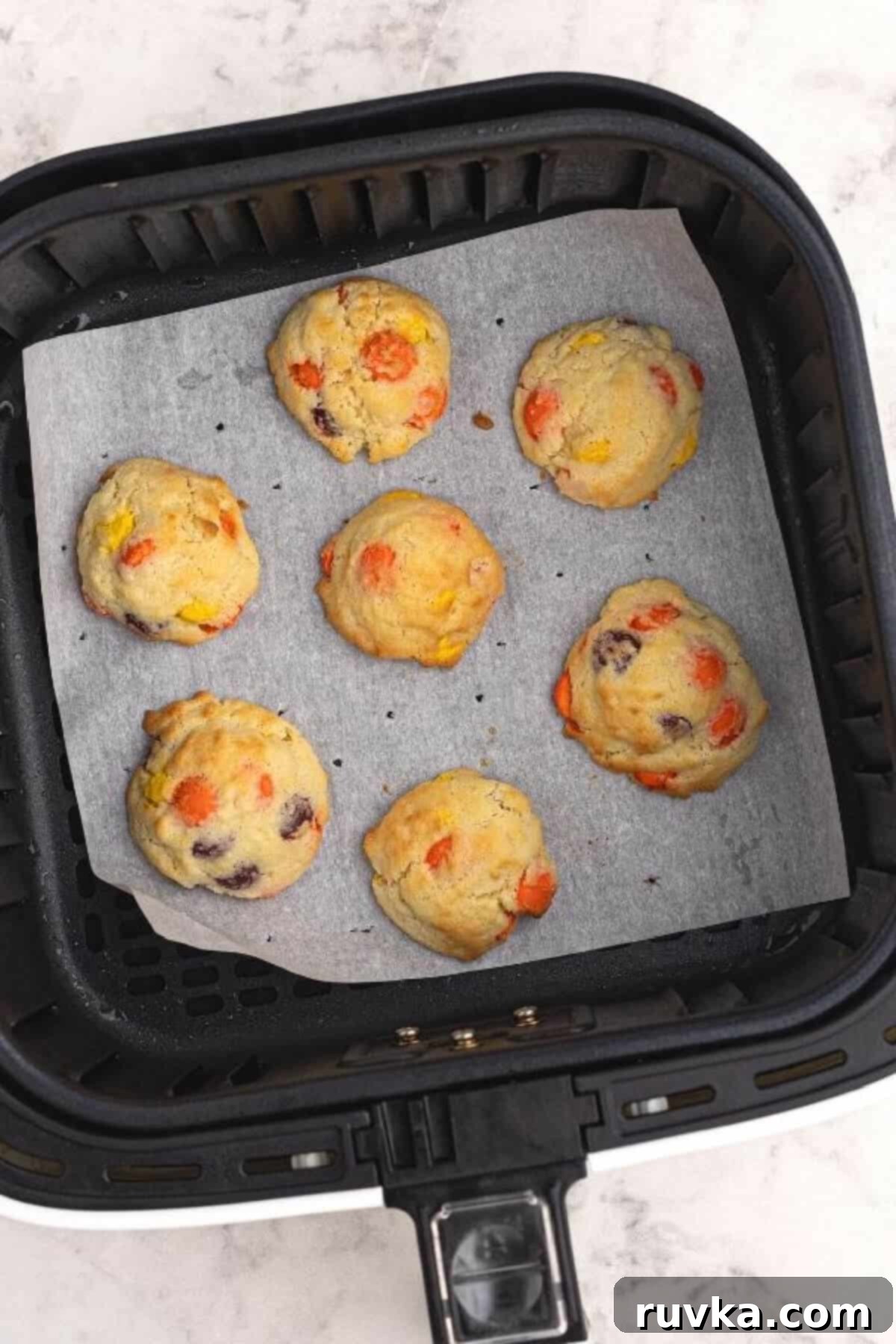Easy Air Fryer Sugar Cookies 4 Air fried sugar cookies in the air fryer basket, ready to be served.