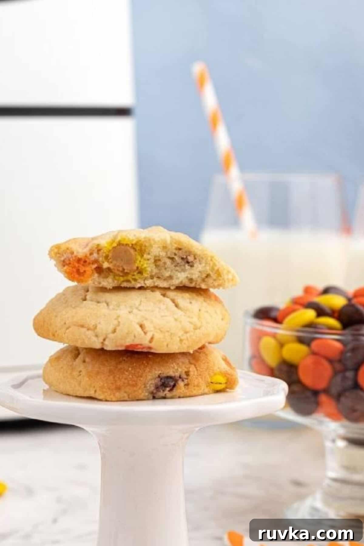 Easy Air Fryer Sugar Cookies 5 sugar cookies stacked on a pedestal with the top cookie cut in half.