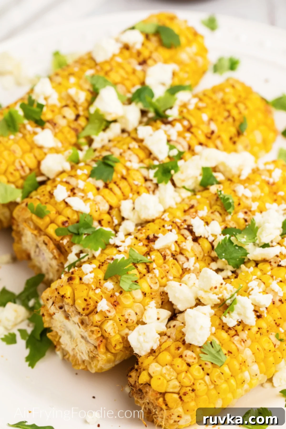 Crispy Air Fryer Elote 2 Air Fryer Mexican Street Corn topped with fresh feta cheese and cilantro. Ready to eat.