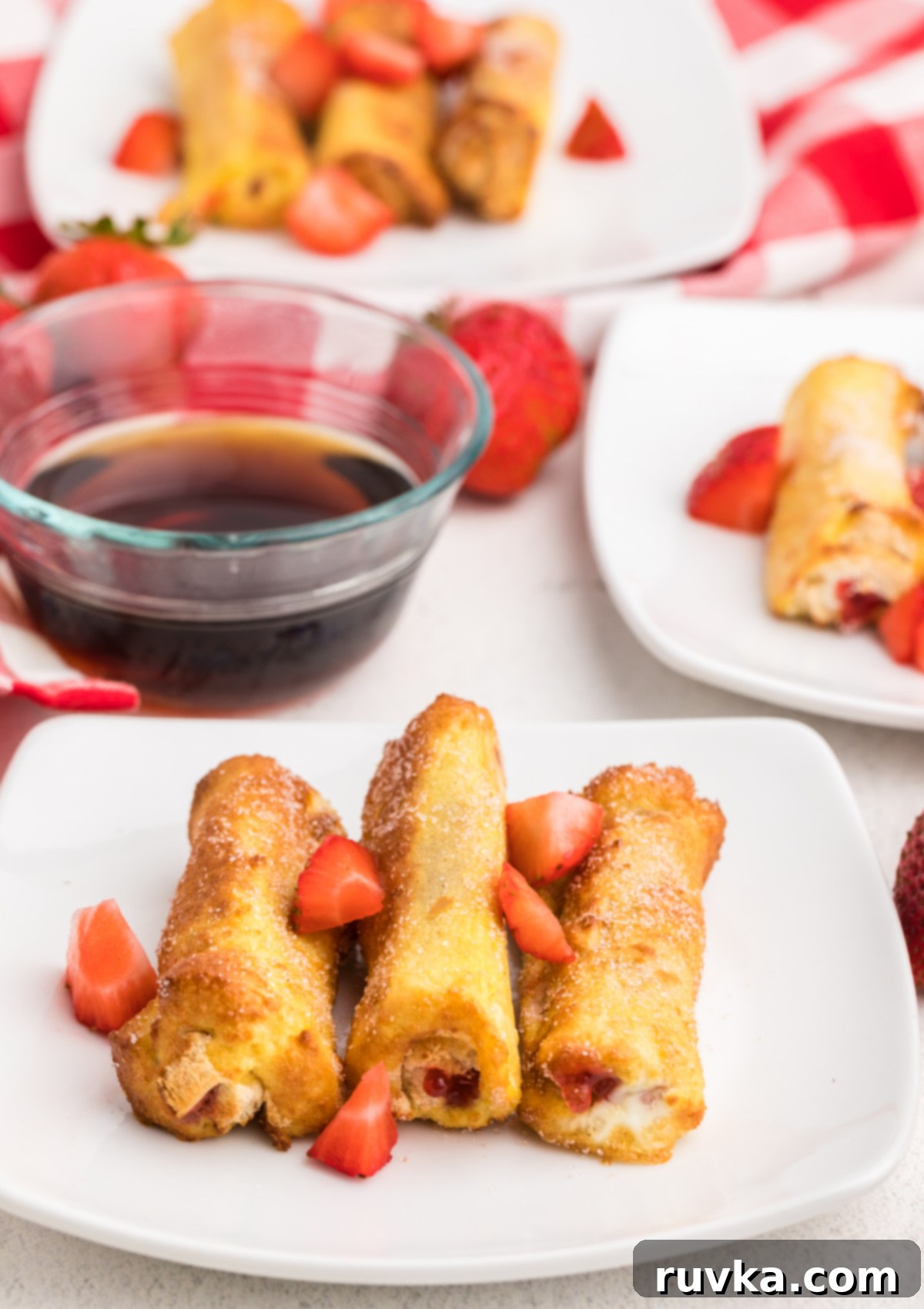 Air Fried Strawberry French Toast Pinwheels 6 French toast roll-ups made in the air fryer and served on a plate.