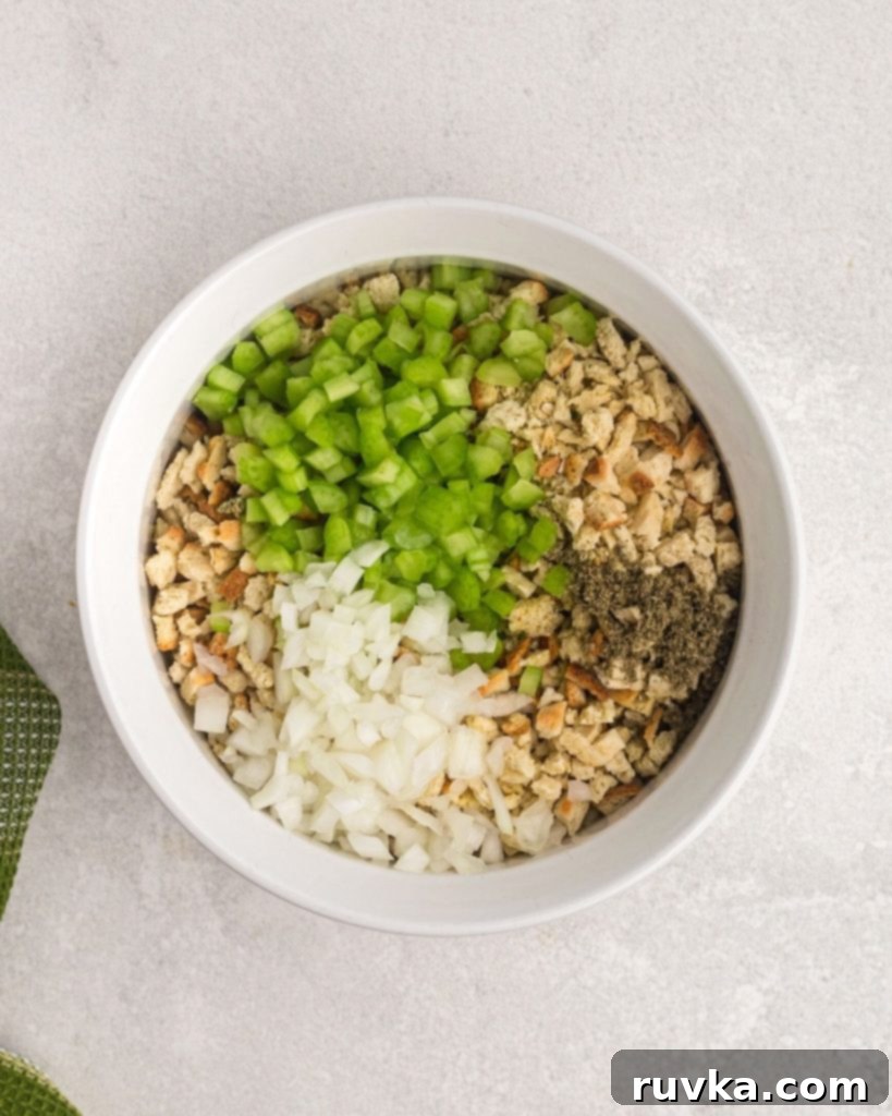 Perfectly Crispy Air Fryer Stuffing 5 breadcrumbs, onion, celery, sage in a white bowl.