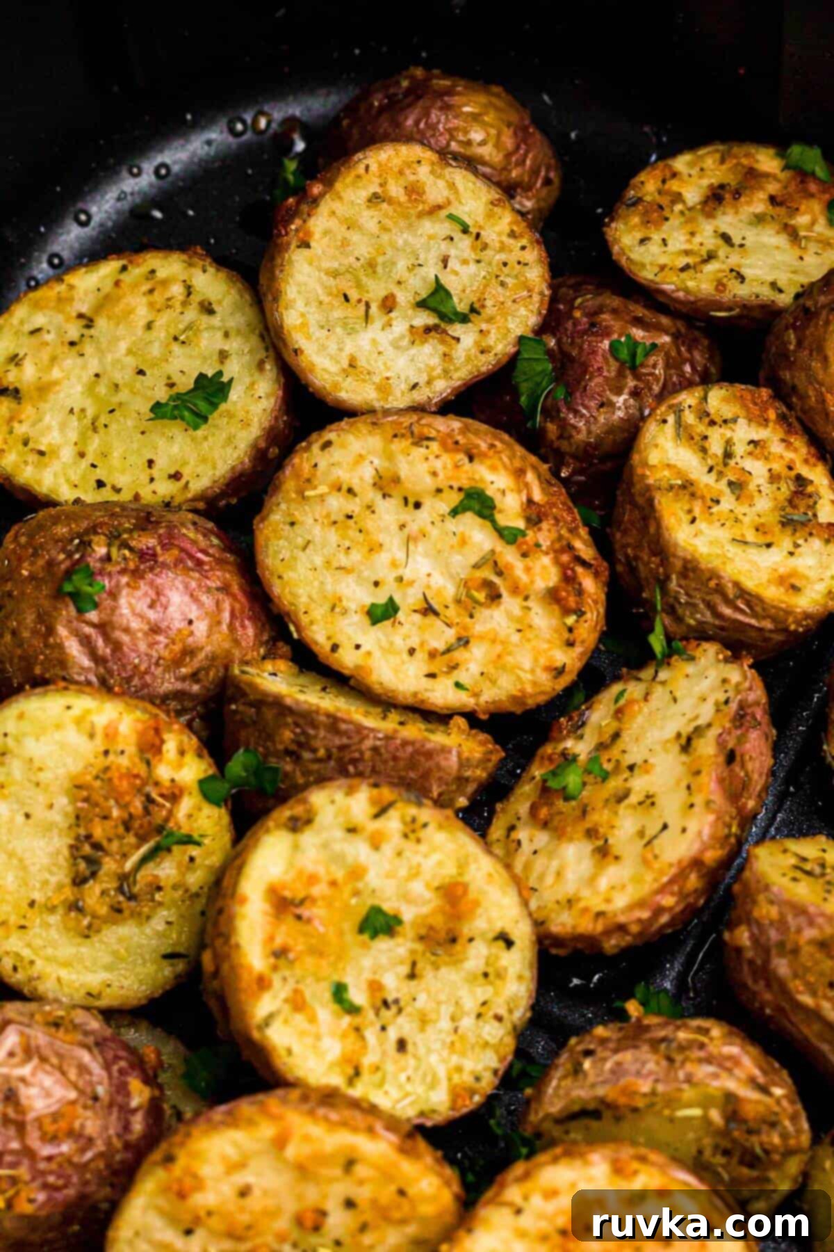 Crispy Air Fryer Potatoes 7 Golden cooked baby red potatoes in the air fryer basket after being cooked.