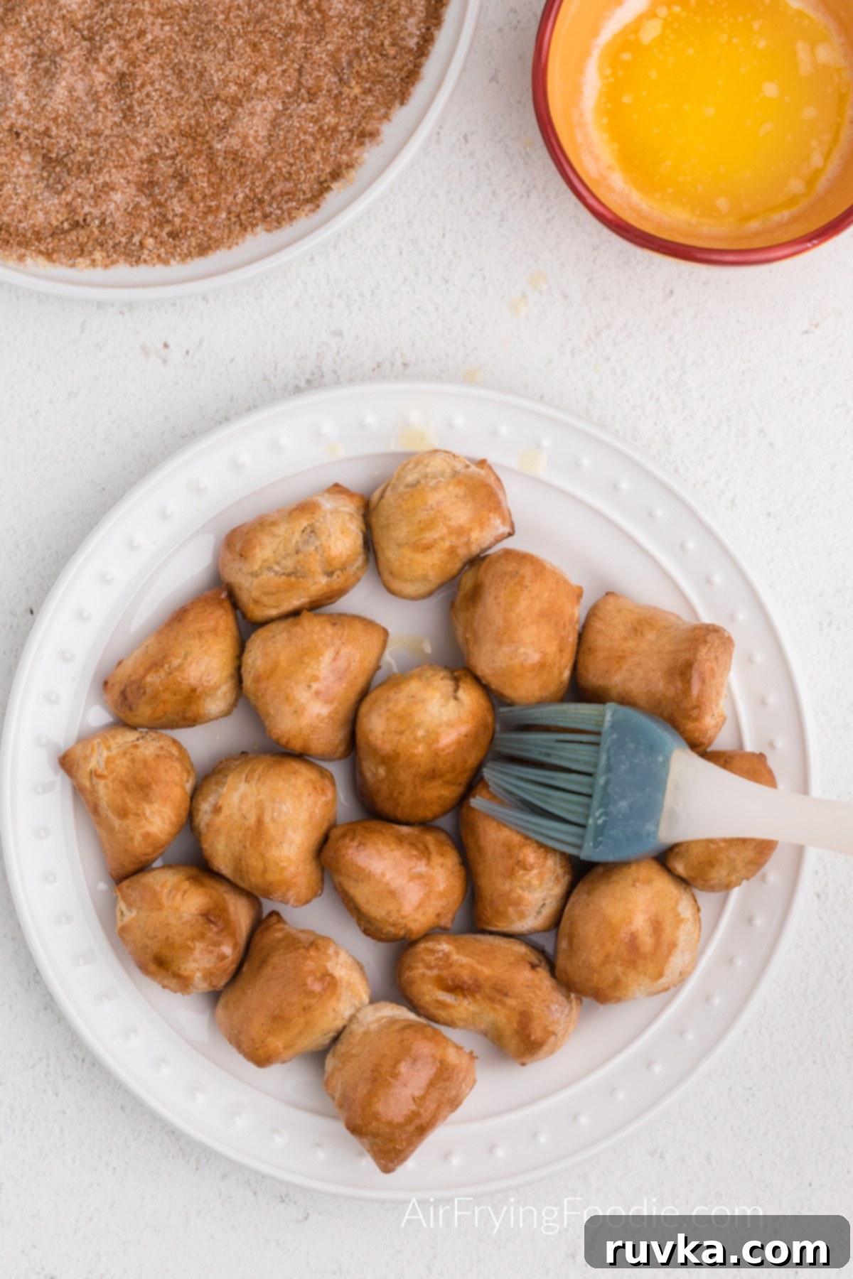 Air Fried Pretzel Perfection 10 brushing pretzel bites with melted butter.