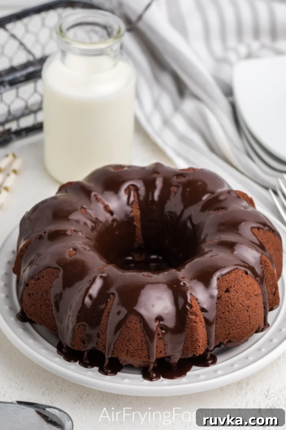 Irresistible Air Fryer Chocolate Bundt 2 Delicious Air Fryer Chocolate Bundt Cake with glossy chocolate frosting, ready to be sliced and enjoyed.