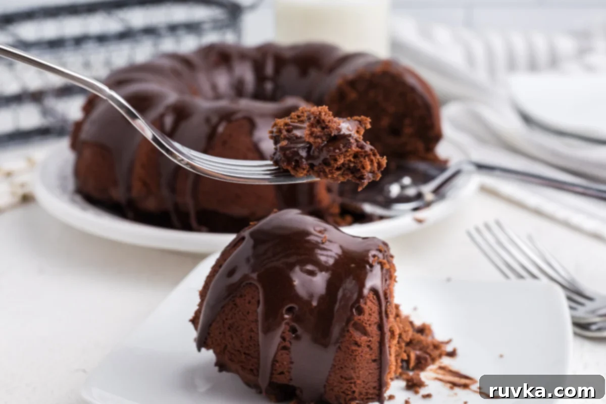 Irresistible Air Fryer Chocolate Bundt 10 Close-up bite shot of a slice of Air Fryer Chocolate Bundt Cake, showcasing its moist interior and rich frosting, making it irresistible.