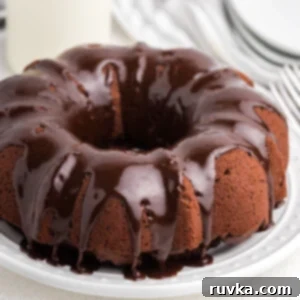 Irresistible Air Fryer Chocolate Bundt 11 A delicious Air Fryer Chocolate Bundt Cake, beautifully frosted and presented on a white plate, ready for serving.