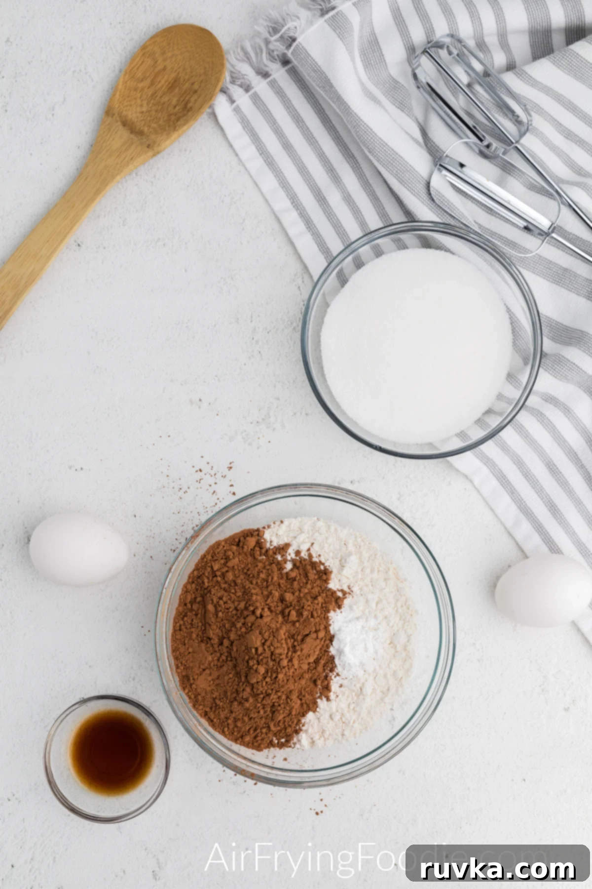 Irresistible Air Fryer Chocolate Bundt 4 Mixing bowl with all-purpose flour, baking powder, and cocoa powder combined, ready for wet ingredients.