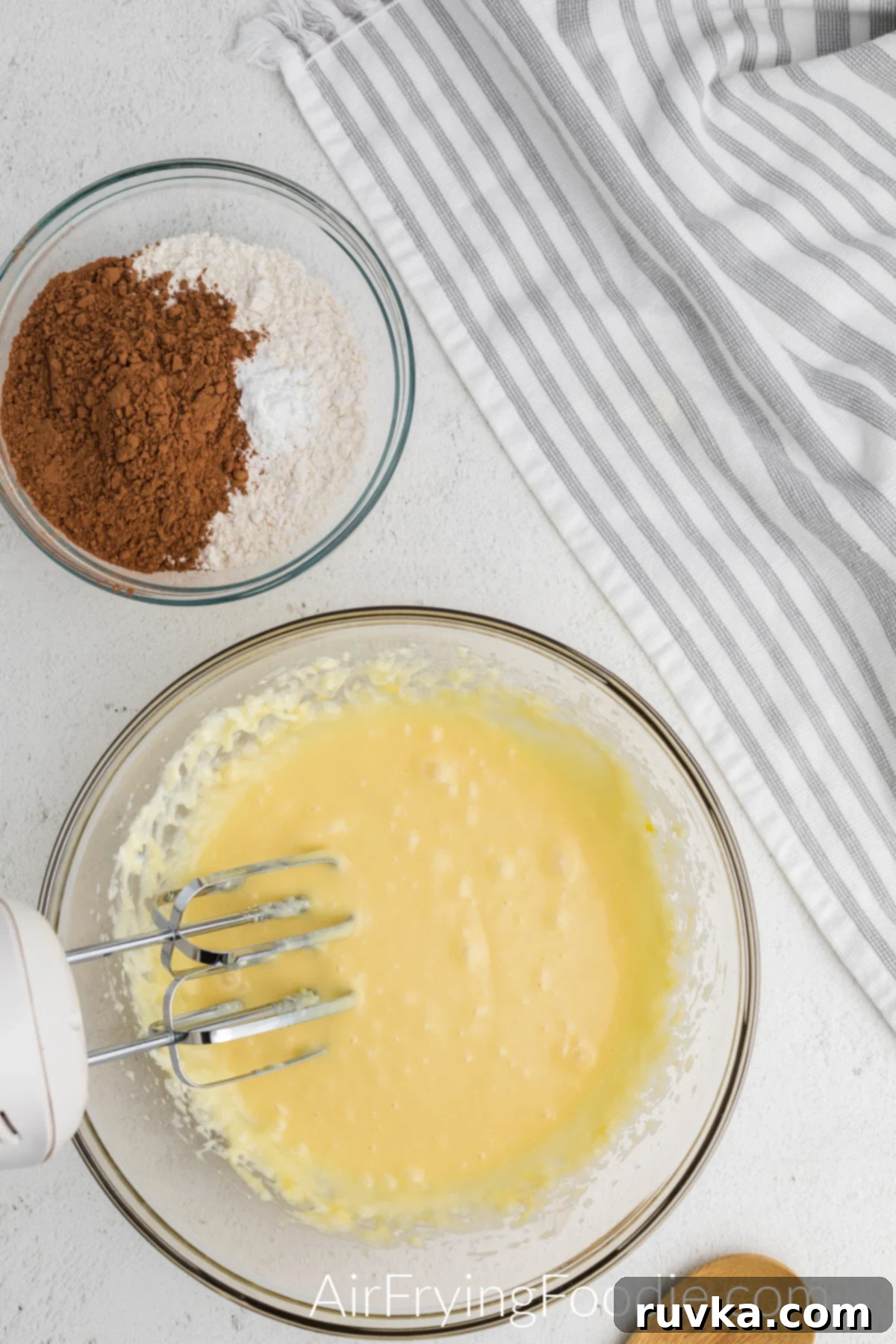 Irresistible Air Fryer Chocolate Bundt 5 Cream cheese, butter, and sugar perfectly creamed together in a mixing bowl with a hand mixer, forming a smooth base for the bundt cake batter.