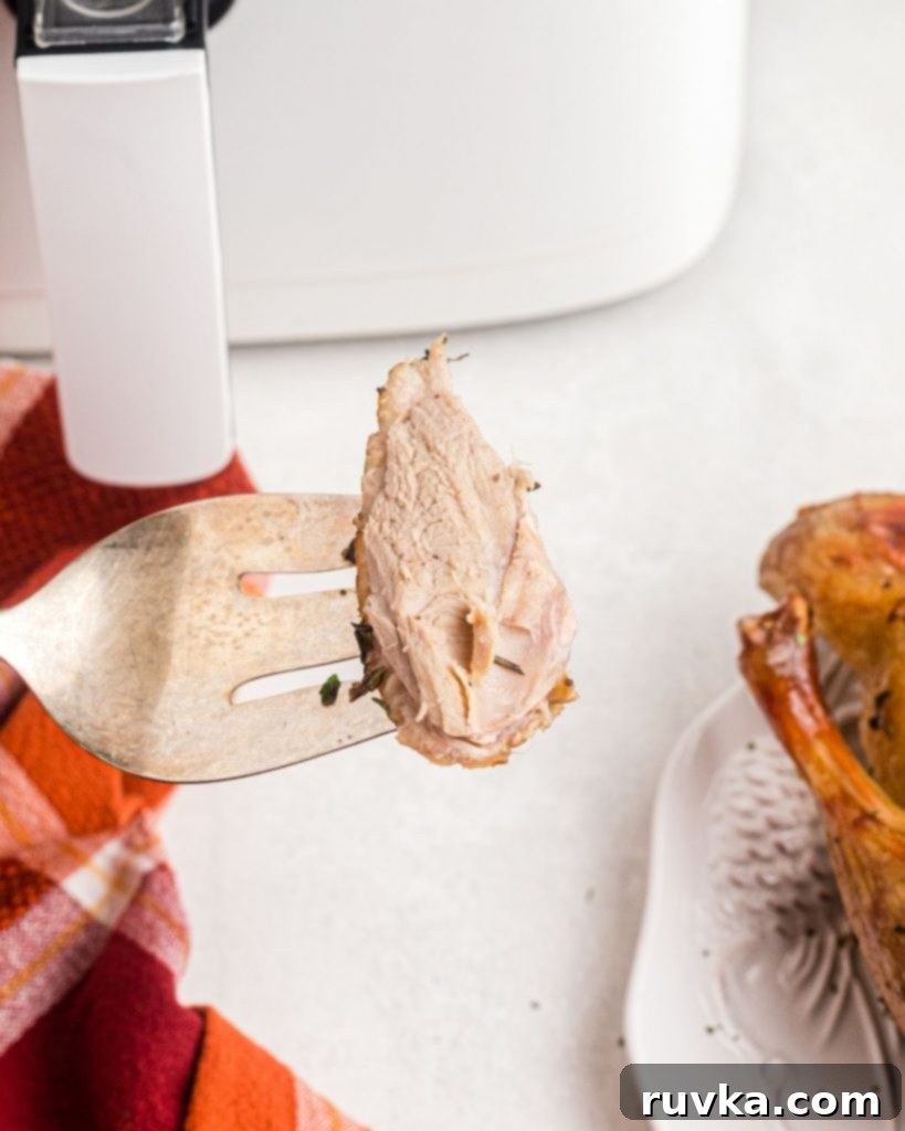Crispy Air Fryer Duck 9 Small bite of duck on a large serving fork.