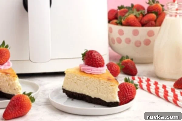 Effortless Air Fryer Cheesecake 2 Cooked creamy cheesecake with a chocolate cookie crust, topped with fresh strawberries, ready to serve.