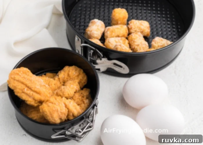Crispy Air Fryer Breakfast Bowl 3 Ingredients for air fryer breakfast bowl laid out, including chicken nuggets, tater tots, eggs, milk, and shredded cheese.