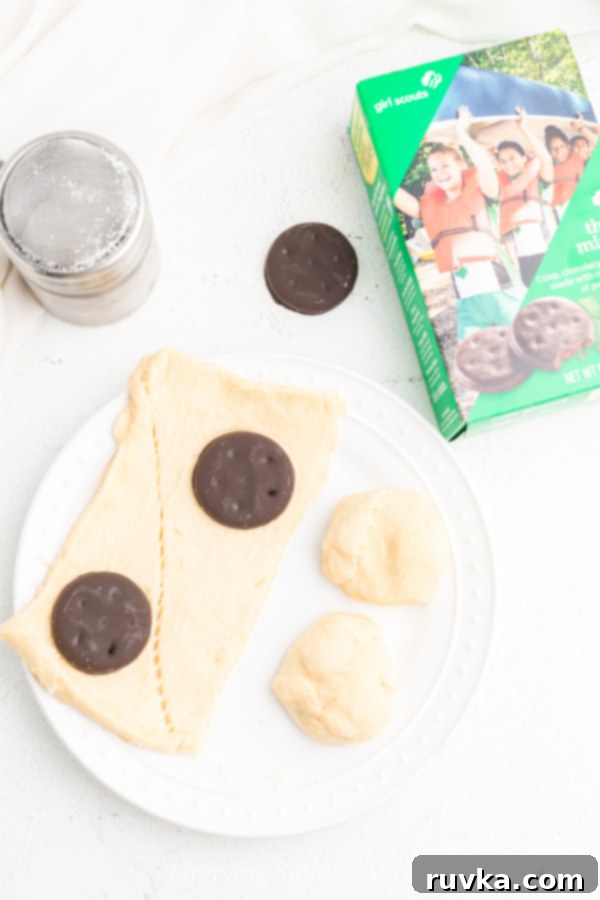 Warm Air-Fried Thin Mints 4 Ingredients needed for air fryer thin mints: thin mints on crescent dough sheets, getting ready to be rolled and fried.