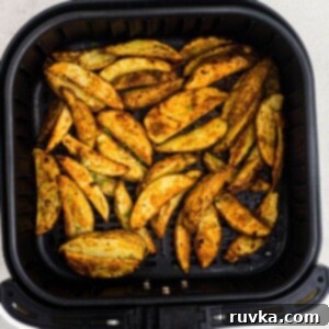 Crispy Air Fryer Sides 11 Golden cooked potato wedges seasoned in the air fryer basket.