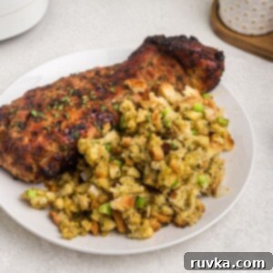 Crispy Air Fryer Sides 4 Golden stuffing with green celery and chopped onions served on a white plate with pork tenderloin.