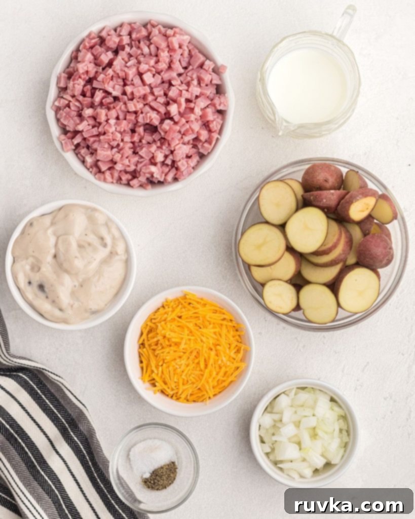 Air Fryer Golden Ham and Potato Bake 3 Collection of ingredients for ham and potato casserole, neatly arranged in white bowls on a white table.