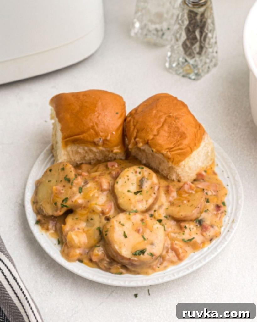 Air Fryer Golden Ham and Potato Bake 7 Plate of air fryer ham and potato casserole, garnished with fresh parsley flakes and served with biscuits on the side.