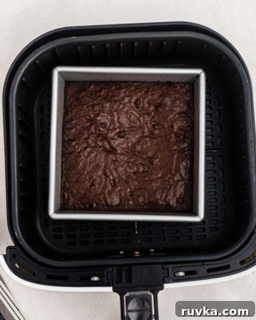 Halloween Air Fryer Mummy Brownies 7 Square pan with cooked brownies in an air fryer basket.
