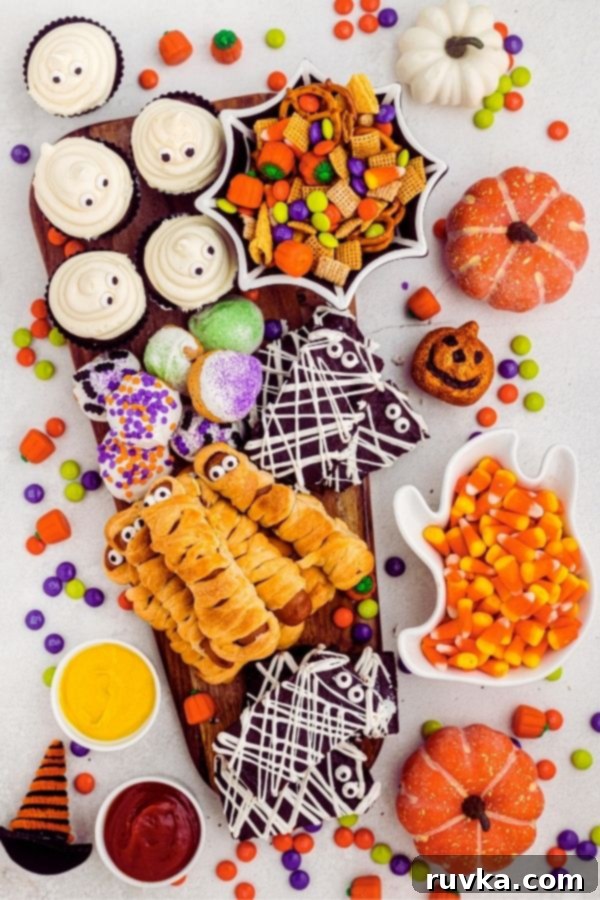 Spooktacular Air Fryer Charcuterie Board 2 A beautifully arranged Halloween charcuterie board filled with a variety of air-fried spooky snacks, candies, and festive decor.