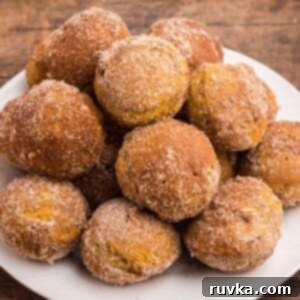 Spooktacular Air Fryer Charcuterie Board 6 Golden pumpkin spice donut holes, air-fried and generously coated in sugar and pumpkin spice, perfect for fall.