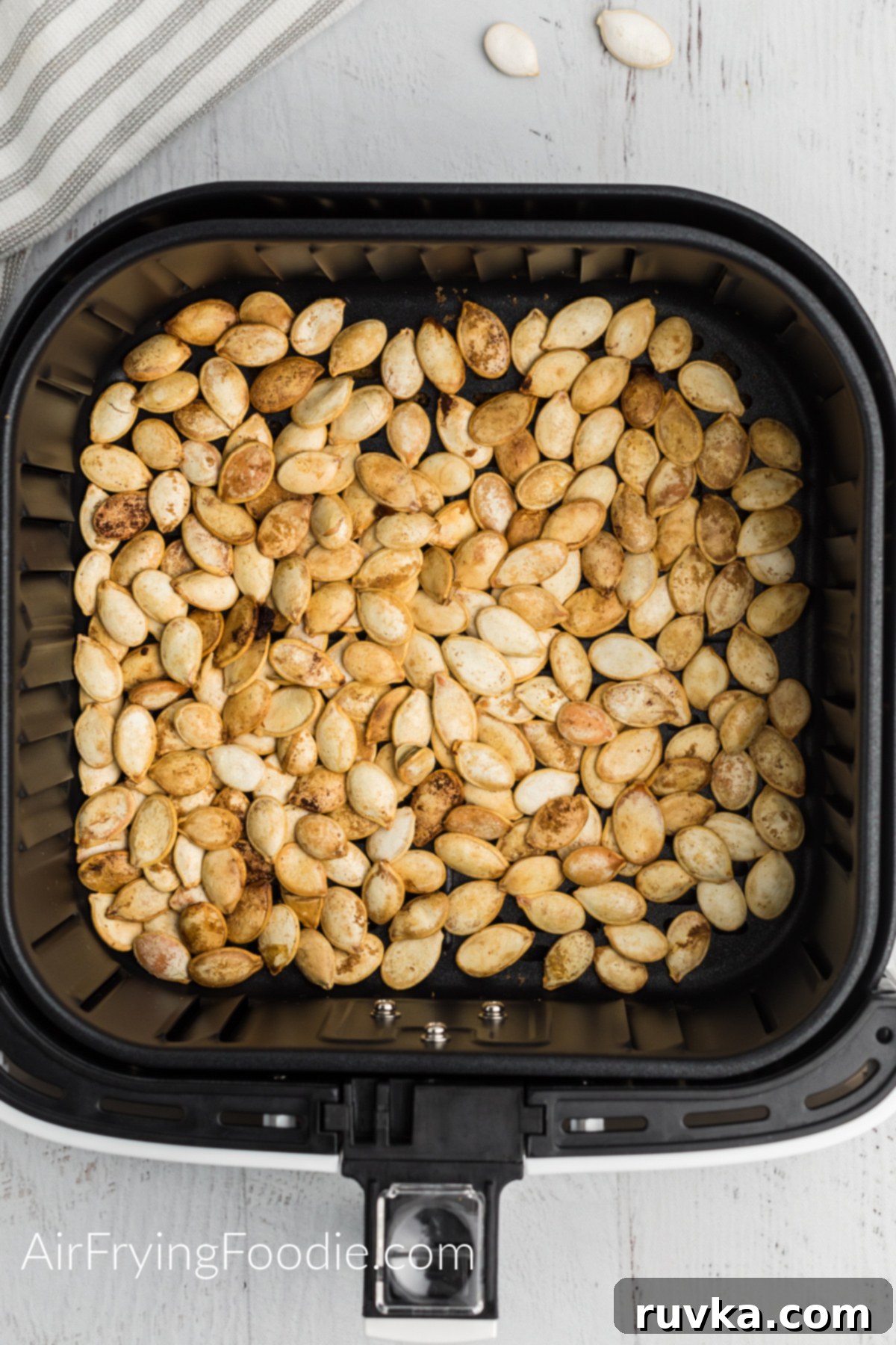 Crispy Air Fryer Pumpkin Seeds 4 Roasted Pumpkin Seeds in the basket of the air fryer.