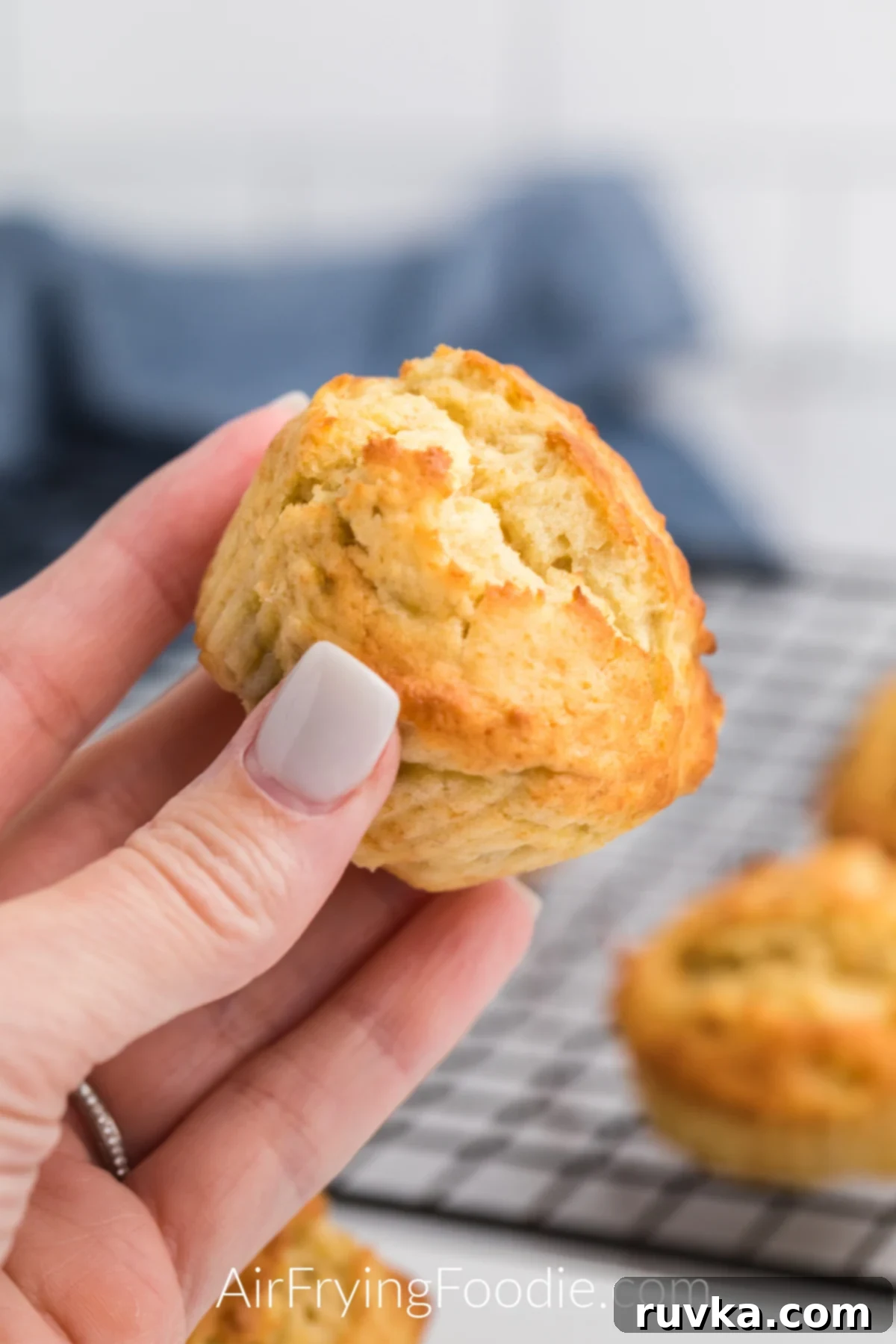 Easy Air Fryer Banana Muffins 2 Air Fryer Banana Muffin in a hand ready to eat.