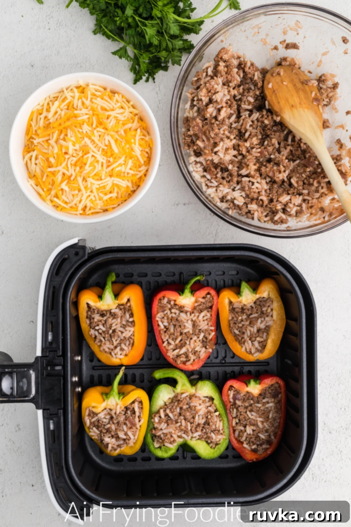 Effortless Air Fryer Stuffed Peppers 4 Peppers halved and stuffed with the meat and rice mixture in a single layer in the basket of the air fryer before cooking.