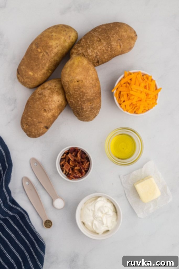Ultimate Air Fryer Twice Baked Potatoes 3 Ingredients needed to make potatoes stuffed with sour cream, cheese, and bacon.